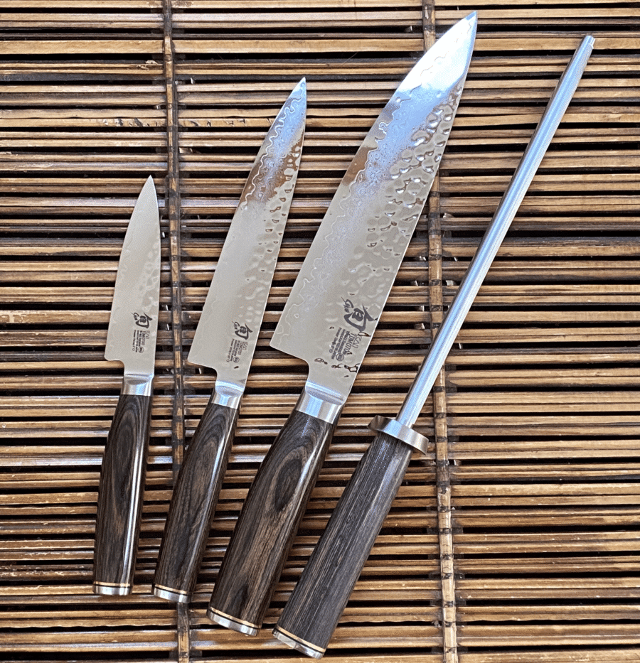 Closeup of Shun knife with water droplets and wooden handle