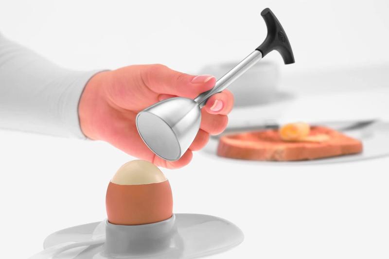 A hand using the Rosle Egg Topper on a boiled egg