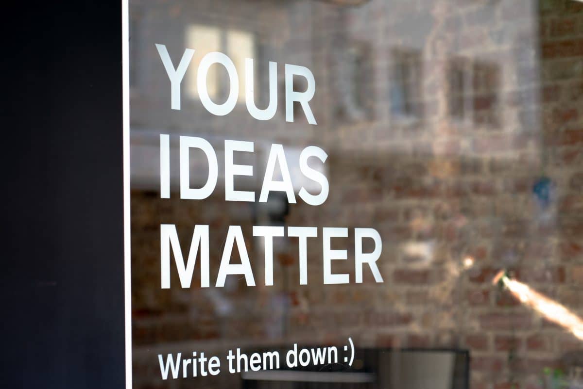 Your Ideas Matter sign displayed on a brick wall.