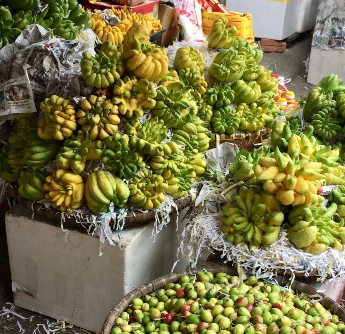 Variety of Buddha's Hand fruits displayed in a market