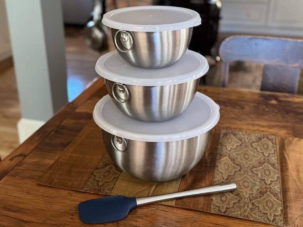 Tovolo nesting bowls with lids on a table with charcoal spatula