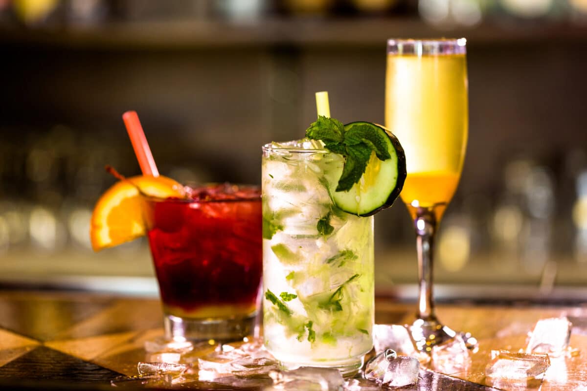 Three colorful aperitfs on a bar