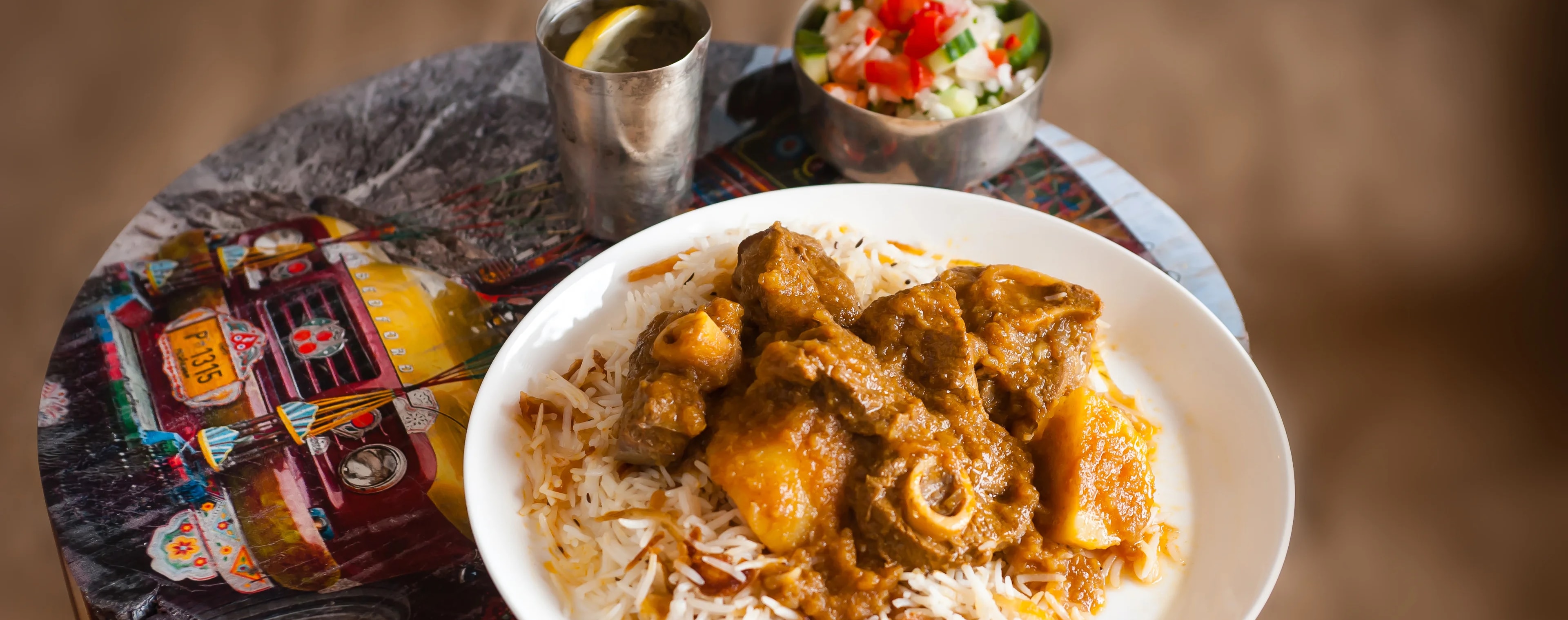 Meat and potatoes in a gravy served over caramelised brown rice and salad.
