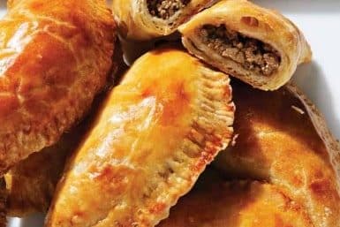 Close-up view of beef empanadas on a plate.