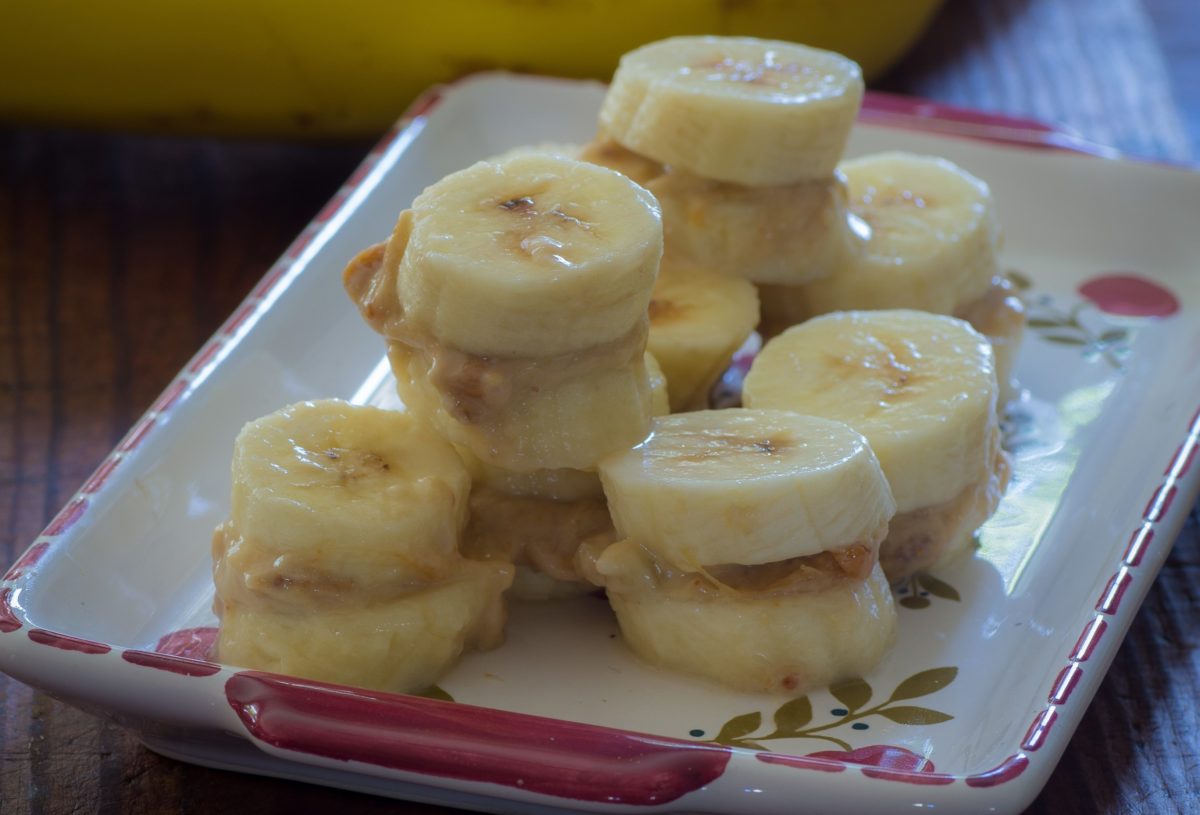 Frozen bananas stacked with layers of creamy peanut butter