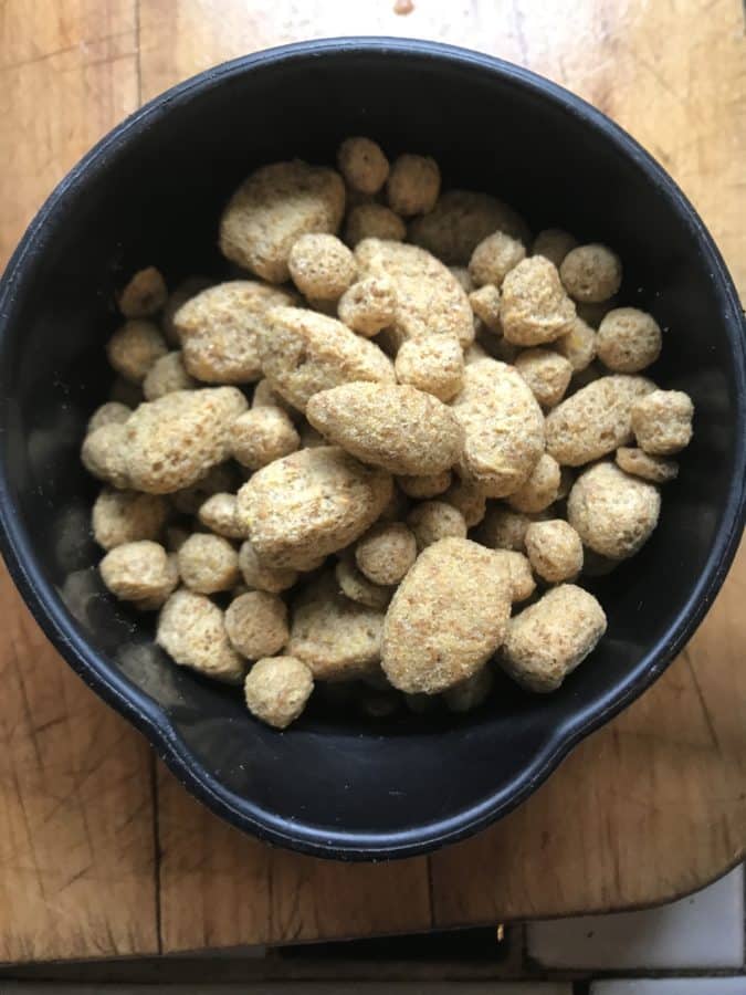 Close-up view of parrot cake pieces in a black bowl.