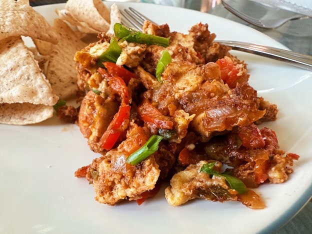 Delicious Menemen dish served with bread on the side.
