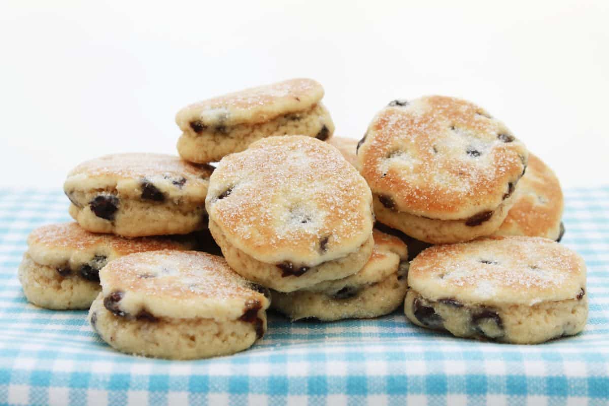 Close-up of traditional Welsh cakes on a checkered cloth.