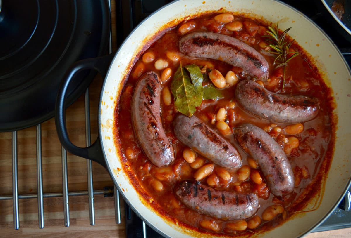 Close-up of venison sausage casserole in a pot.